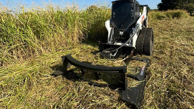 mowing high grass in field